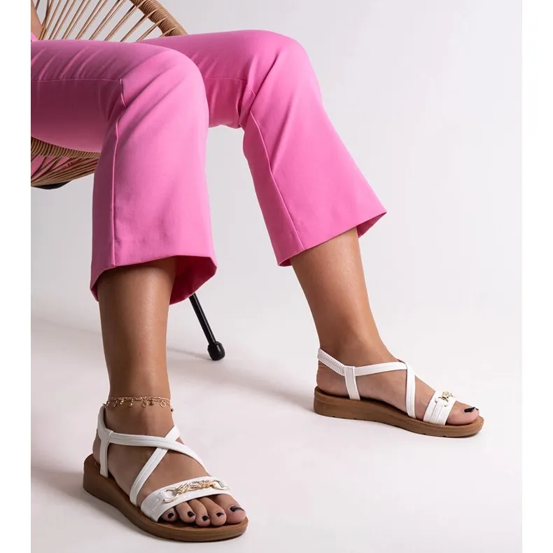 White sandals with a gold buckle by Pamphila